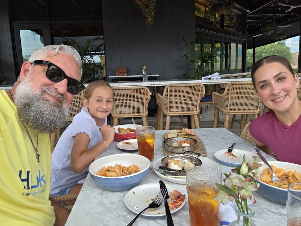 Heath Ledet enjoying a meal with family at an outdoor restaurant