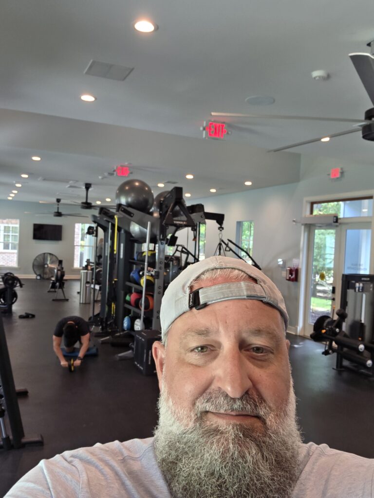 Heath Ledet taking a selfie inside a modern fitness center